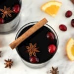 Two glasses of mulled wine with garnishes.