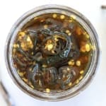 Top down view of a jar of candied jalapenos (also called cowboy candy)
