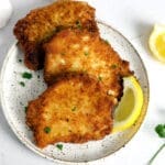 Plate of German Schnitzel with lemon wedge.