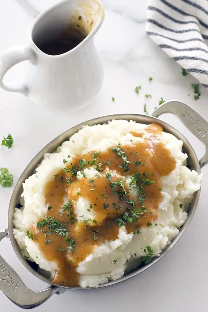 Bowl of cajun gravy over mashed potatoes.