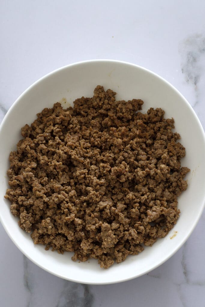Crispy ground beef in a white bowl.