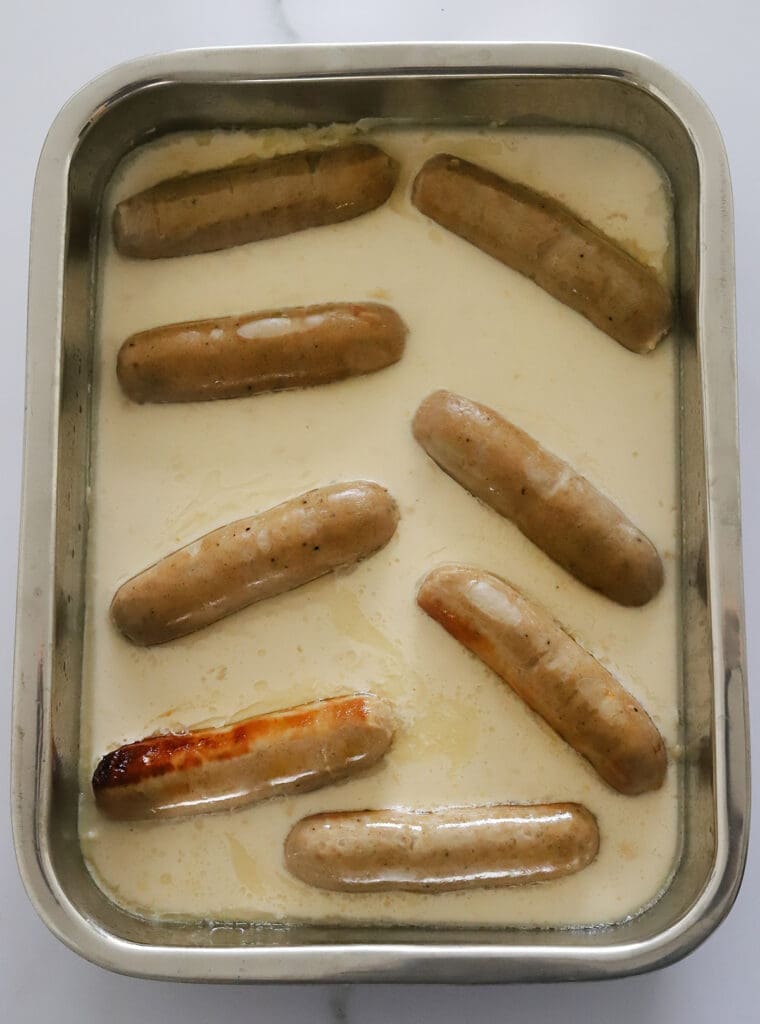 Yorkshire pudding batter poured over sausages. 