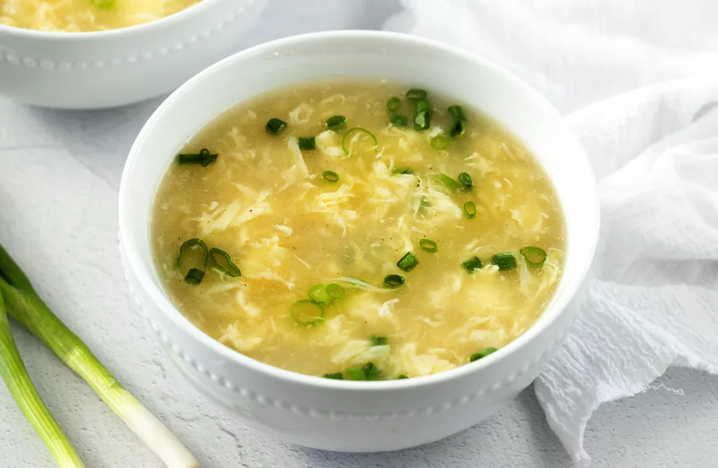 Bowl of egg drop soup in a white bowl.
