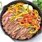 Steak Fajitas in a cast iron skillet.