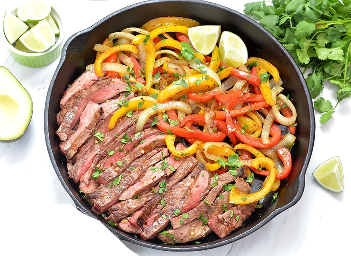 Steak Fajitas in a cast iron skillet.