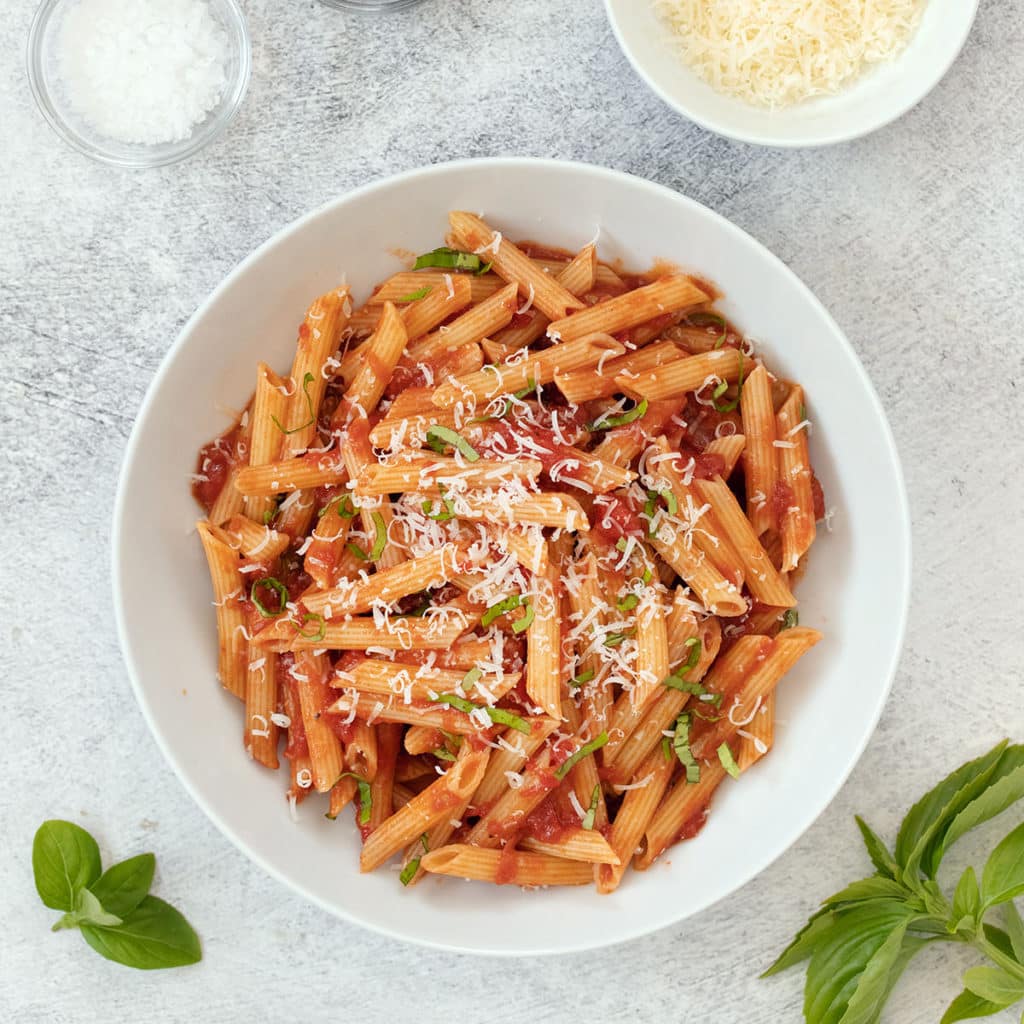 White bowl of penne pomodoro.