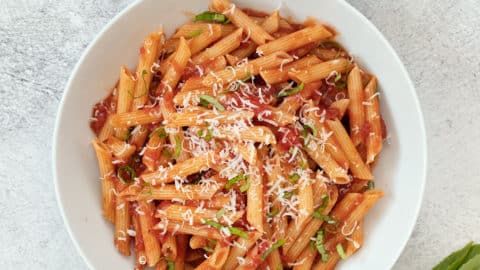 White bowl of penne pomodoro.