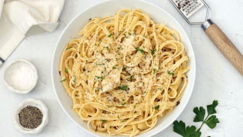 White bowl filled with truffles with pasta.
