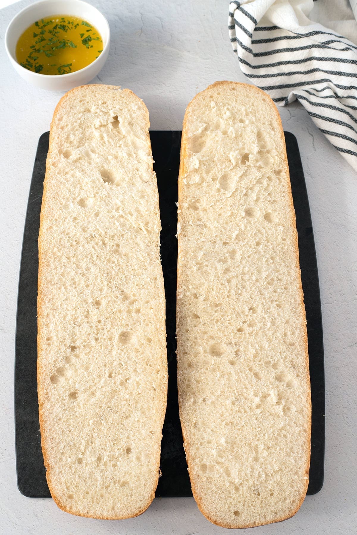 Slices of french bread on a cutting board.