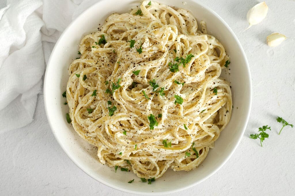 White bowl full of Boursin cheese pasta.