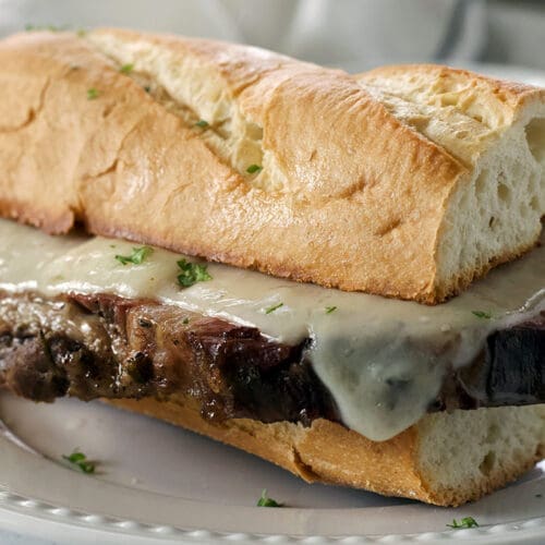 Prime Rib French Dip Sandwich on a white plate.