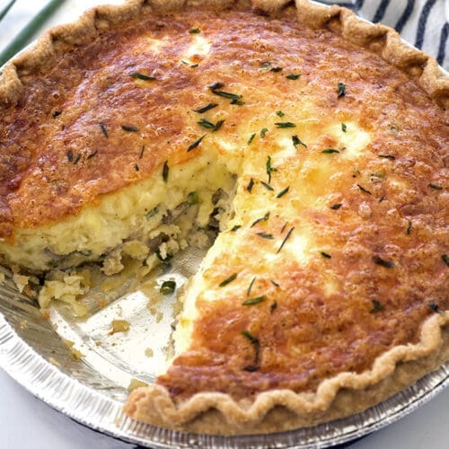 Leftover prime rib quiche with one slice missing.