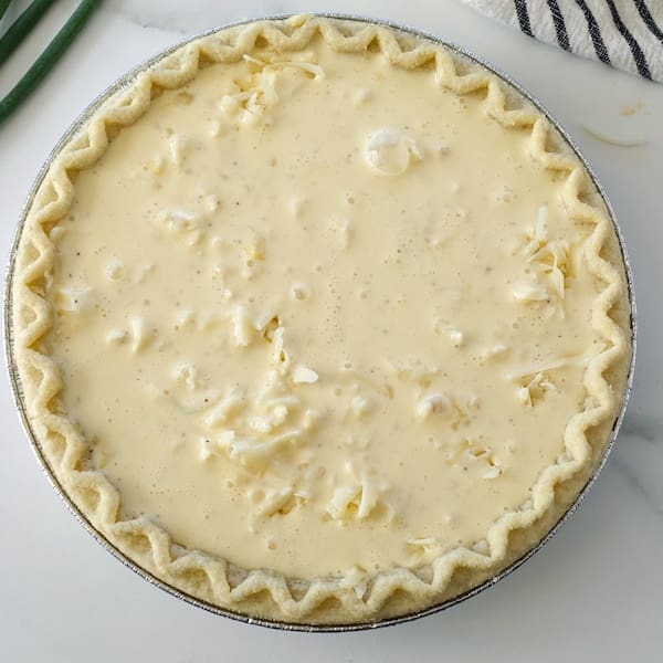 Uncooked pie crust with eggs. 