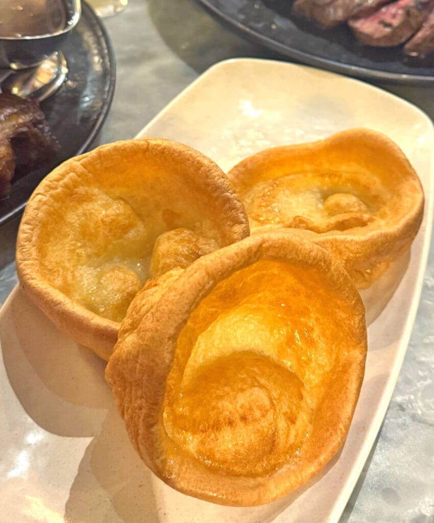 White serving tray with three Yorkshire Puddings.